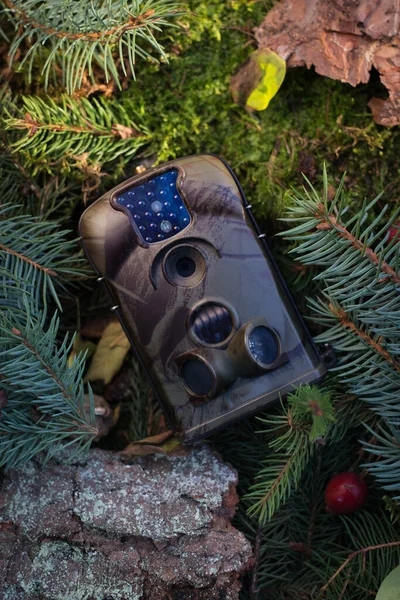Advertising photo of Trap or Hunting Camera With Infrared Light and a motion detector on the Forest Floor
