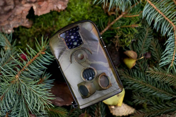 Advertising photo of Trap or Hunting Camera With Infrared Light and a motion detector on the Forest Floor