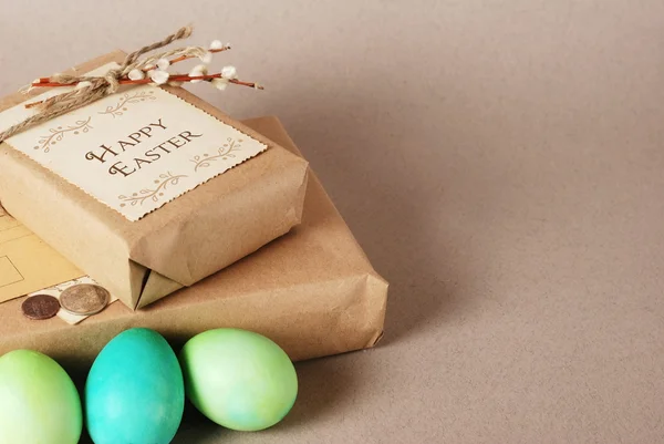 Vintage still life with easter eggs, white bunny and gift boxes in craft paper — Stock Photo, Image