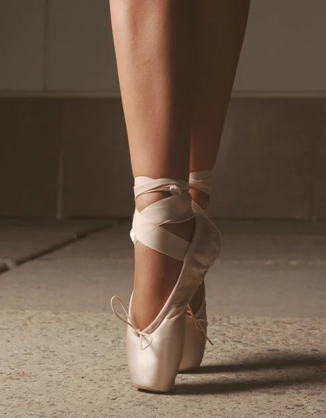 Feet of ballerin dancing in ballet shoes
