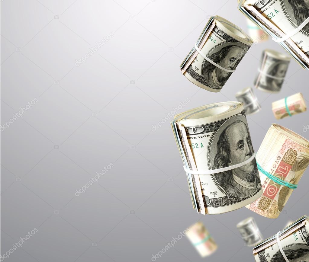 Rolls Of Unaited states Dollars and Ukrainian money. Abstract money background