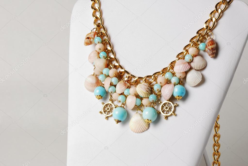 Beautiful necklace in marine style with seashells, and little wheels