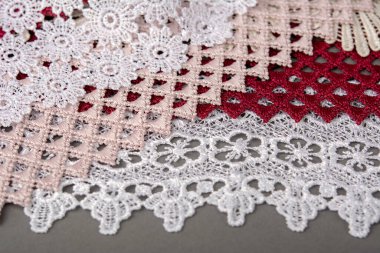 Bir yığın kırmızı, beyaz. Bej rengi yelken şampanyası lüks, lüks, gri arka planda dantel kumaş. giysi dikmek için keten dekorasyonunu kullan.