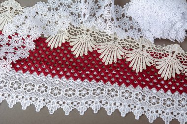 Bir yığın kırmızı, beyaz. Bej rengi yelken şampanyası lüks, lüks, gri arka planda dantel kumaş. giysi dikmek için keten dekorasyonunu kullan.