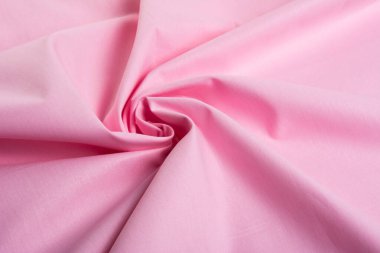 Pembe pamuk doğal kumaş, ipliklerin dokuması, kıvrımlı kıvrımlar. Elbise ve gömlek dikmek için. Dikiş dikmek ve terzi dükkanını kullanmak için. Metin için boşluk.