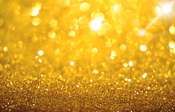 Yellow golden glittering Christmas lights. Blurred abstract back