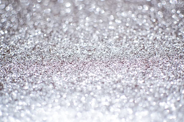 Blurry abstract bokeh lights on grey background with sparkle. — Stock Photo, Image