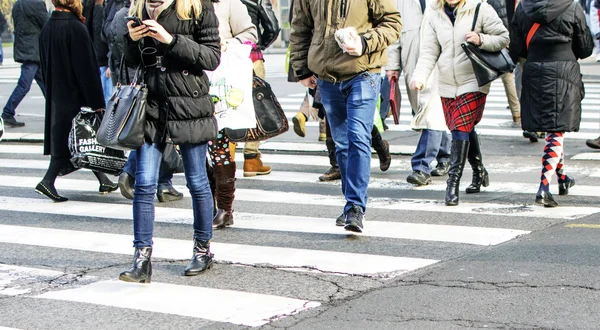 Moto pedoni offuscati che attraversano la strada illuminata dal sole — Foto Stock