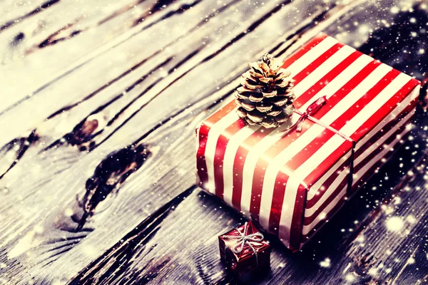 Christmas pinecone on gift box — Stock Photo, Image