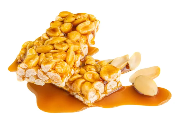 Nut bar with peanuts and melted caramel syrup isolated on white background. Crushed Muesli energy cereal snack