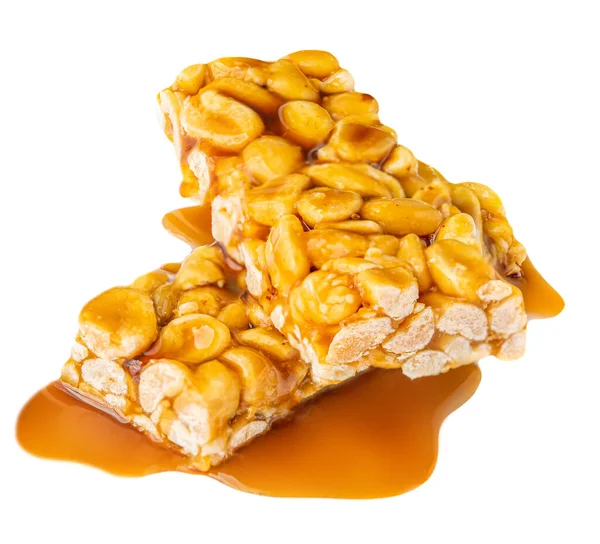 Nut bar with peanuts and melted caramel syrup isolated on white background. Crushed Muesli energy cereal snack