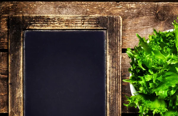 Salad over blackboard — Stock Photo, Image