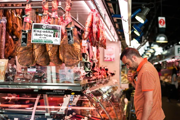 Spanska mannen tittar på kött shop — Stockfoto