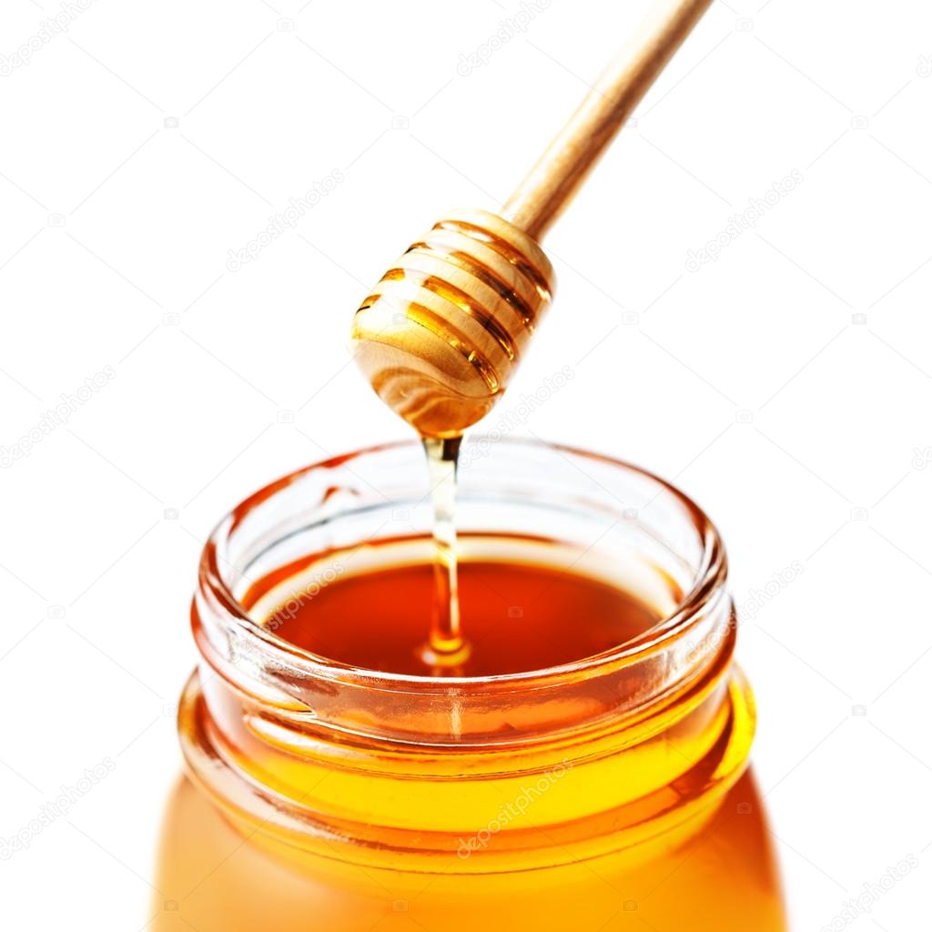 Honey in a glass jar with honey dipper