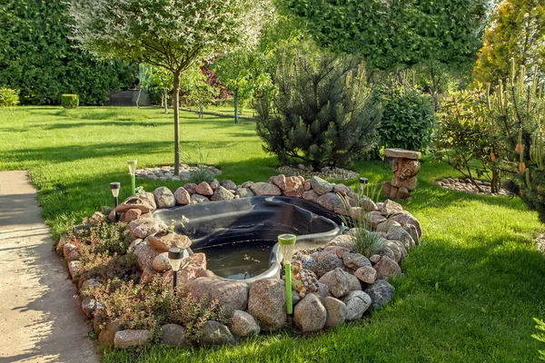 Artificial pond in the garden — Stock Photo, Image