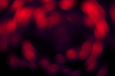 Bulanık radyal eğimli koyu kırmızı soyut arkaplan. Karışık dairesel doku