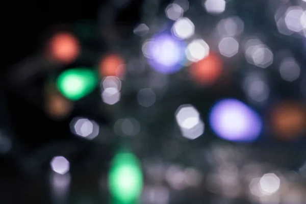 Blurred lights dark gray background. Abstract bokeh with soft light. Shiny festive christmas texture