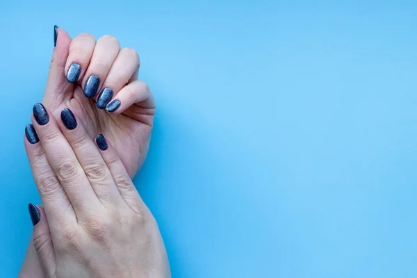 Female Hands Beautiful Manicure Dark Glittered Nails Blue Background Copy — Stock Photo, Image