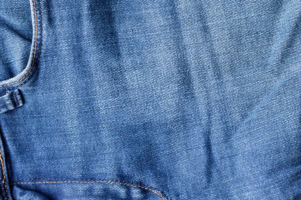 Niebieskie dżinsy tekstury tkaniny. Dżinsy z przednią kieszenią tłem — Zdjęcie stockowe