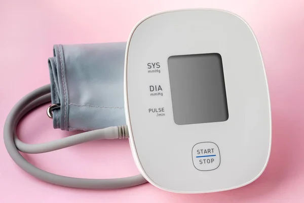 Automatic blood pressure monitor on pink background. Medical electronic tonometer — Stock Photo, Image