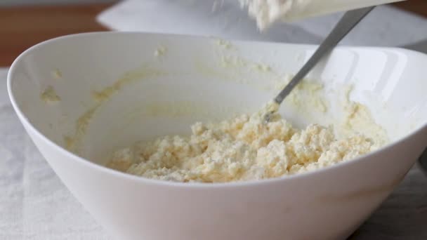 Mjöl keso deg i en vit skål. Processen att göra ostmassa bagels eller croissanter — Stockvideo