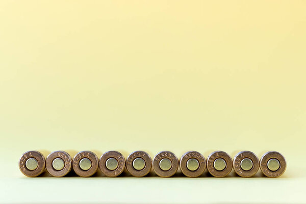 Bullets bottom on yellow background. Cartridges 7.62 caliber for Kalashnikov assault rifle closeup with copy space