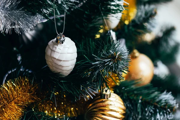 Weiße Spielzeugkegel am geschmückten Weihnachtsbaum — Stockfoto