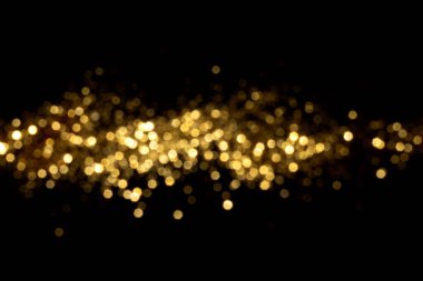 Siyah arka planda altın bulanık bokeh ışıkları. Kutlamak için ışıldayan yıldızlar