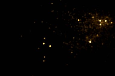 Siyah arkaplanda altın bulanık bokeh ışıkları
