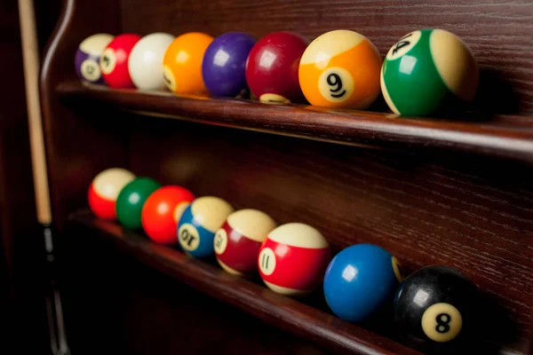 Rafta bilardo topları, Amerikan bilardosu için bilardo topları, Rus bilardosu için toplar, tahta arka planda renkli ya da beyaz toplar. Yakın plan fotoğraf. Yumuşak odak.