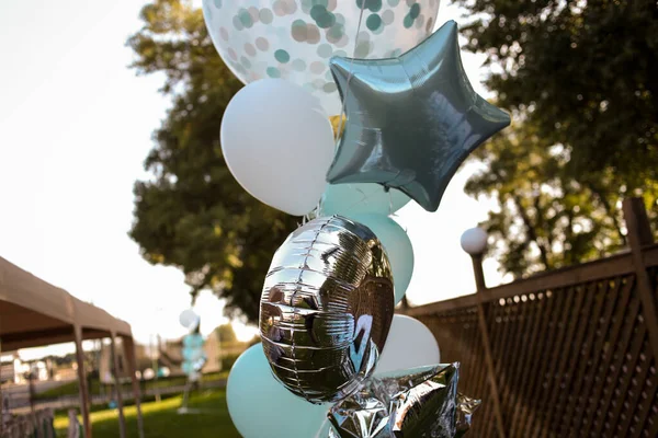 Bouquet of colorful balloons. colorful balloons filled with helium, in the summer , autumn , spring park. colorful balloons, blue, white, silver isolated. Balloons of many colors in a large heap
