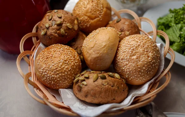 round buns with bran, nuts and sesame seeds. Bread in the basket. Freshly baked the whole grain bread rolls with oats, nuts and seeds. wholegrain bun. close-up photo. soft focus