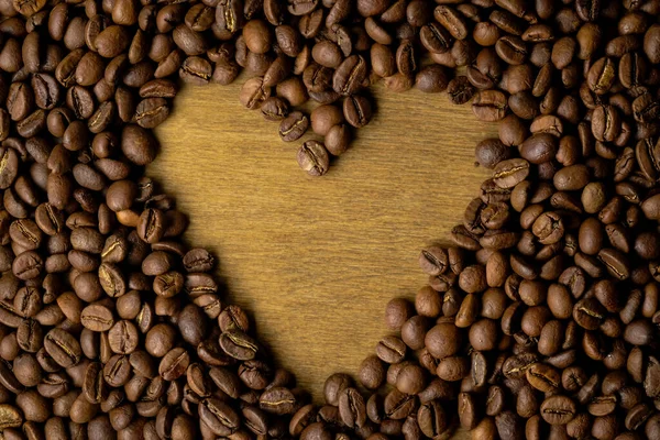 Kaffeebohnen Hintergrund. Gebratener Kaffee auf Grunge-Holz Hintergrund. — Stockfoto