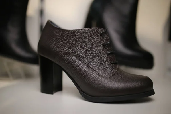 Stylish leather, lacquered women's shoes on the shelf in the store. women's shoes on the stand. Female style, fashion.