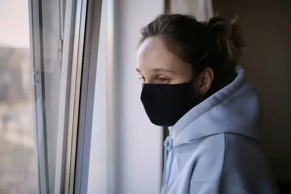 Girl Black Mask Blue Shirt Standing Window House Isolation Girl — Stock Photo, Image