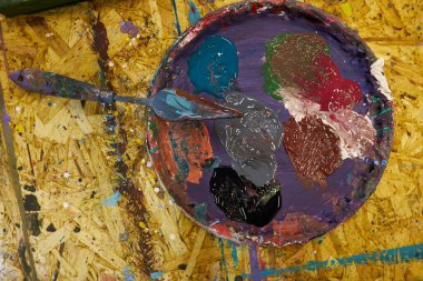 multi-colored acrylic paints on a wooden background. 