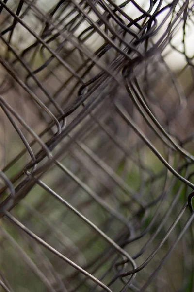 Twisted mesh. welded wire mesh twisted into a roll background. fence stretched mesh background. mesh close-up photo