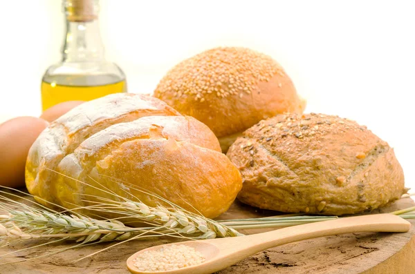 Fresh bread and wheat on the wooden — Stock Photo, Image