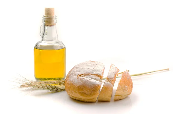 Fresh bread and wheat on white — Stock Photo, Image