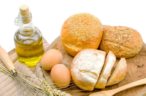 Fresh bread and wheat on the wooden — Stock Photo, Image