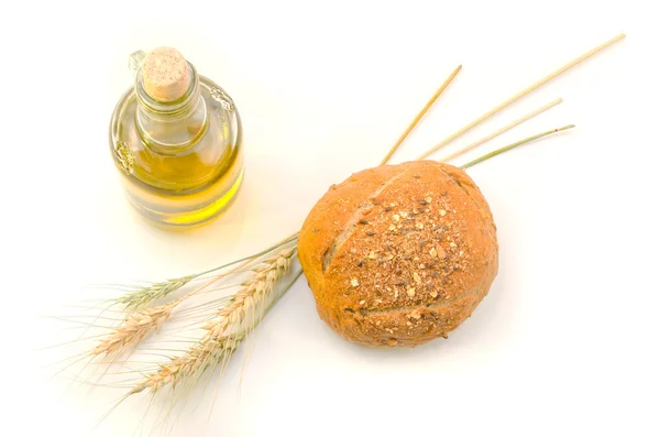 Fresh bread and wheat on white — Stock Photo, Image