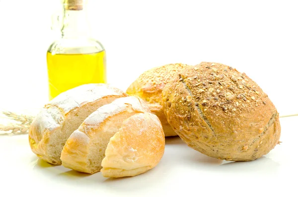 Fresh bread and wheat on white — Stock Photo, Image