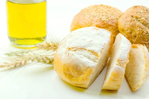 Pane fresco e grano su bianco — Foto Stock