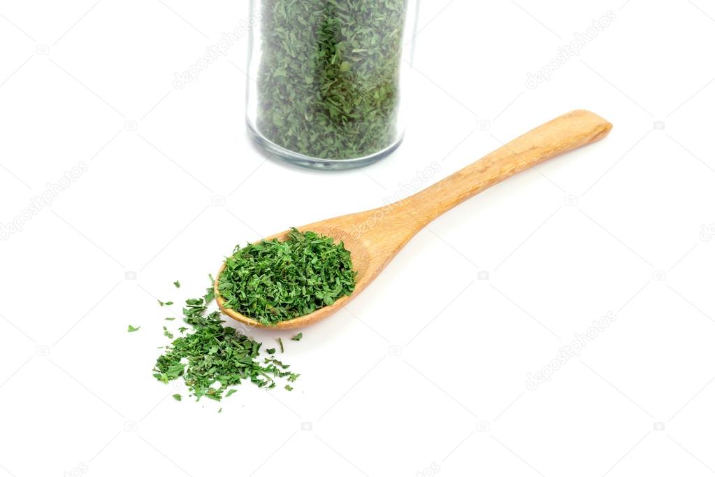 dried parsley in wooden spoon 