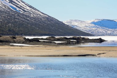 İlkbahar Gjevilvatnet Gölü 'nde, Trollheimen Ulusal Parkı' ndaki dağların manzarası. 
