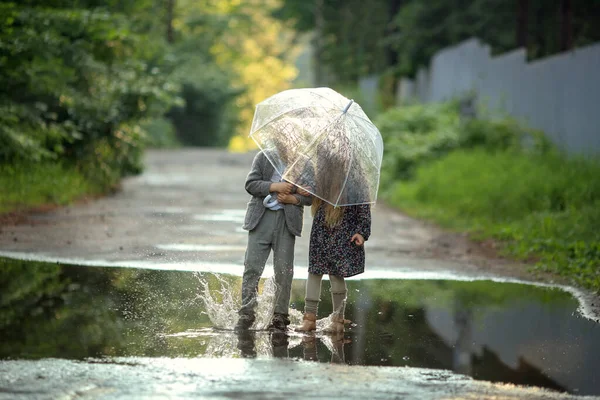 Beautiful Girl Dress Boy Suit Holding Umbrella Jumping Puddles Summer — Stock Photo, Image