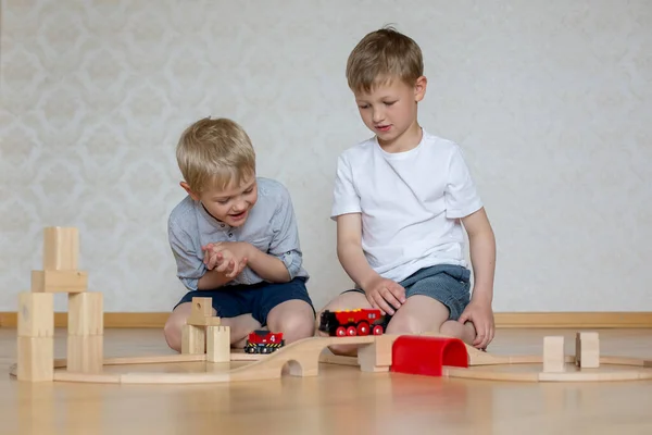 Two Cheerful Blond Brother Sitting Floor Playing Wooden Blocks Train — Stock Photo, Image