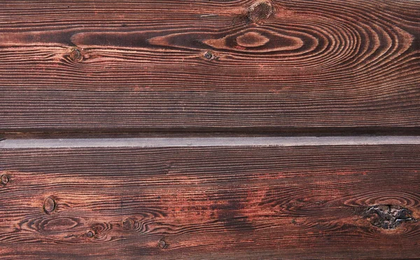 Texture of natural mahogany wood from two horizontal boards, background.