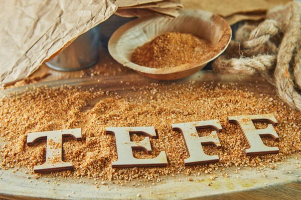 Teff, an alternative to ancient gluten-free grain with the name written in wooden letters. Teff has become a popular choice for healthy eating.