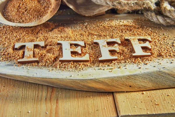 Teff, an alternative to ancient gluten-free grain with the name written in wooden letters. Teff has become a popular choice for healthy eating.